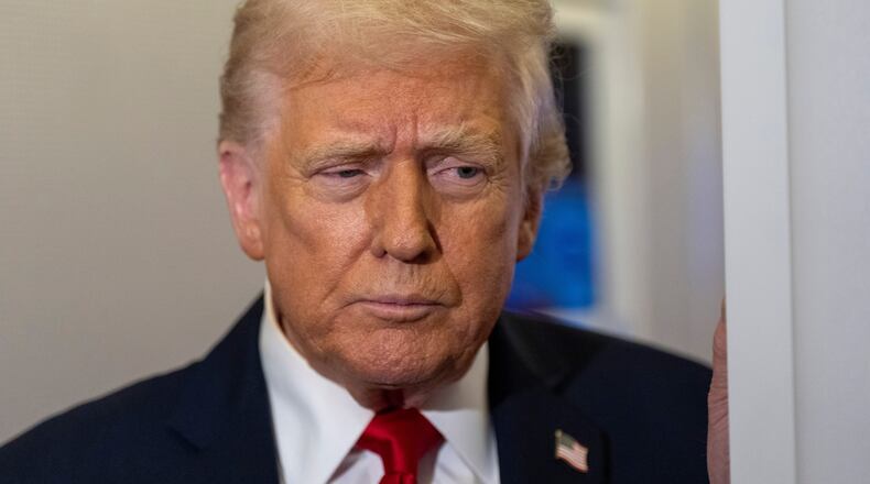 President Donald Trump speaks with reporters while in flight on Air Force One from Joint Base Andrews to his Mar-a-Lago estate in Palm Beach, Fla., Tuesday, Nov. 25, 2025. (AP Photo/Alex Brandon)