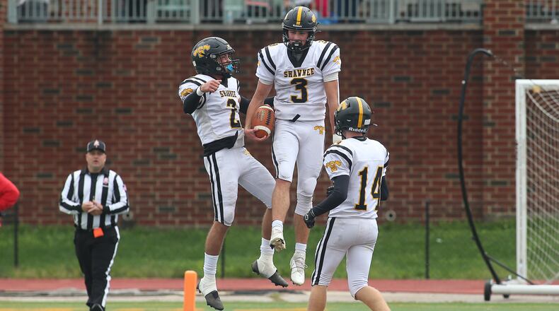 Shawnee High School junior RJ Griffin celebrates with junior Brian Morgan (2) and sophomore Ed Boehmer (14) after scoring a touchdown during their Division V, Region 20 playoff game against Purcell Marian on Saturday afternoon at Walnut Hills High School in Cincinnati. Griffin scored two touchdowns as the Braves won 21-16. Michael Cooper/CONTRIBUTED