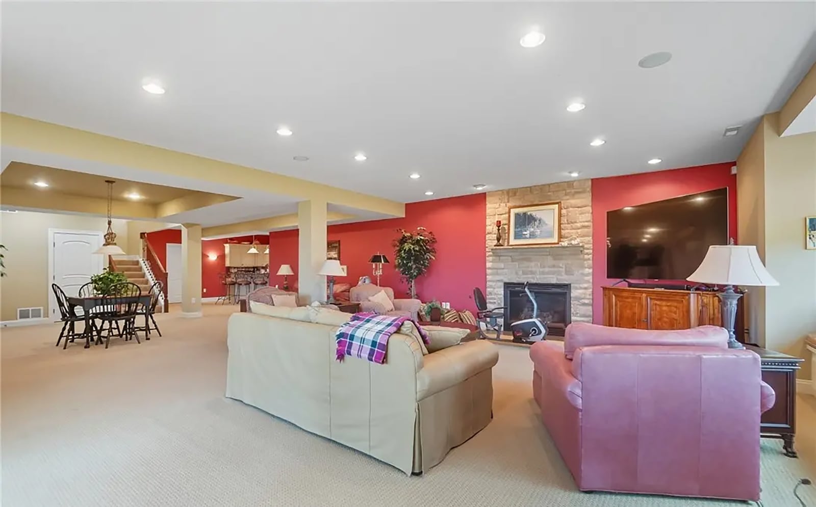 The finished basement has a recreation room with carpeting and a walk out to a covered patio. There is a wet bar with bar seating, a sink, beverage cooler and dishwasher. There is also a gas fireplace. CONTRIBUTED