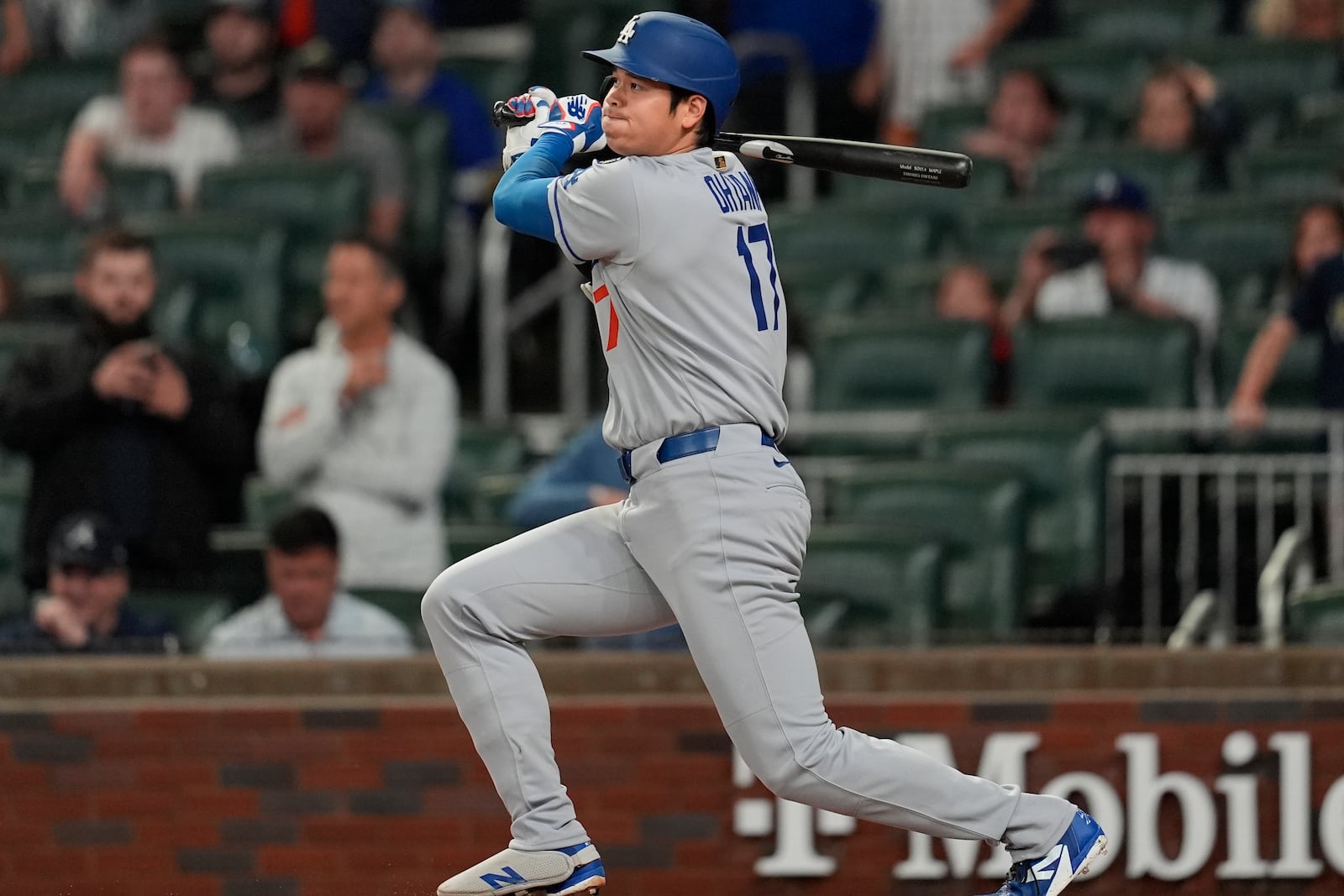 Los Angeles Dodgers two-way player Shohei Ohtani (17) hits a single against the Atlanta Braves in the first inning of a baseball game, Saturday, May 3, 2025, in Atlanta. (AP Photo/Mike Stewart)