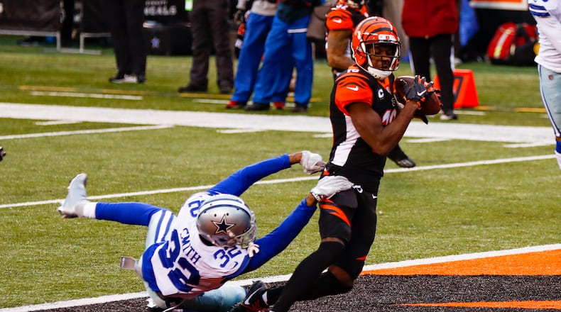 Cincinnati Bengals wide receiver A.J. Green (18) makes a catch for a touchdown over Dallas Cowboys cornerback Saivon Smith (32) in the first half of an NFL football game in Cincinnati, Sunday, Dec. 13, 2020. (AP Photo/Aaron Doster)