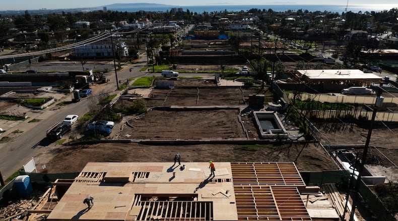 An aerial view shows houses being rebuilt on cleared lots months after the Palisades Fire, Dec. 5, 2025, in the Pacific Palisades neighborhood of Los Angeles. (AP Photo/Jae C. Hong)