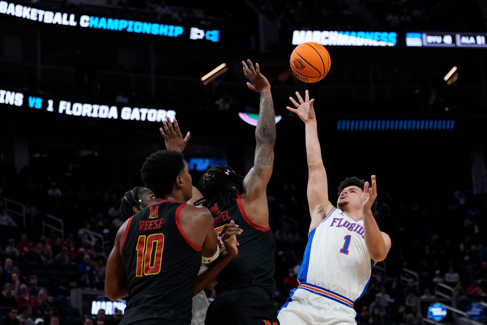 Florida guard Walter Clayton Jr. (1) shoots against Maryland guard Selton Miguel, center, and forward Julian Reese (10) during the first half in the Sweet 16 of the NCAA college basketball tournament, Thursday, March 27, 2025, in San Francisco. (AP Photo/Godofredo A. Vásquez)