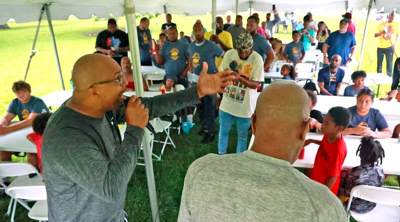 Chris Wallace, organizer of the My Brother's Keeper "Stop the Violence" Community Cookout, welcomes everyone to the event at Davey Moore Park Saturday, July 8, 2023. The event featured food, music, games and the Rock of Legends dedication at the newly refurbished Davey Moore basketball courts. BILL LACKEY/STAFF