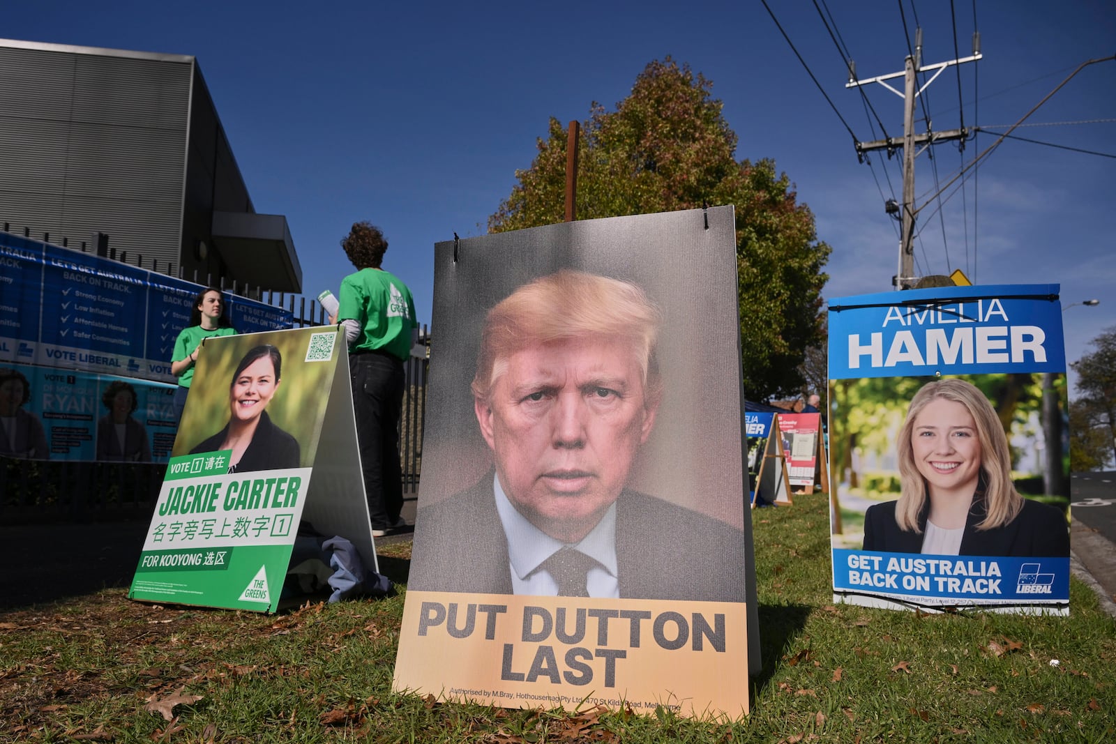 A campaign corflute depicting the Leader of the Opposition Peter Dutton as U.S. President Donald Trump outside a polling booth in Melbourne, Australia, Saturday, Australia, May 3, 2025. (Joel Carrett/AAP Image via AP)