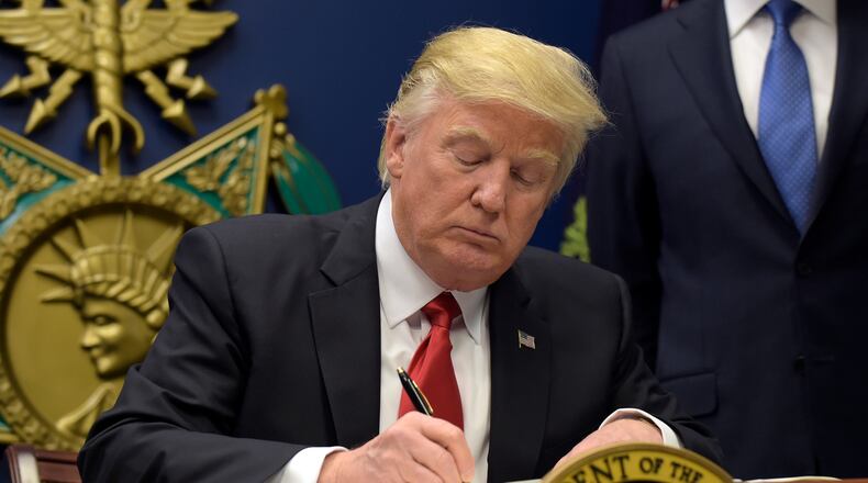 President Donald Trump signs an executive order on extreme vetting during an event at the Pentagon in Washington, Friday, Jan. 27, 2017. (AP Photo/Susan Walsh)