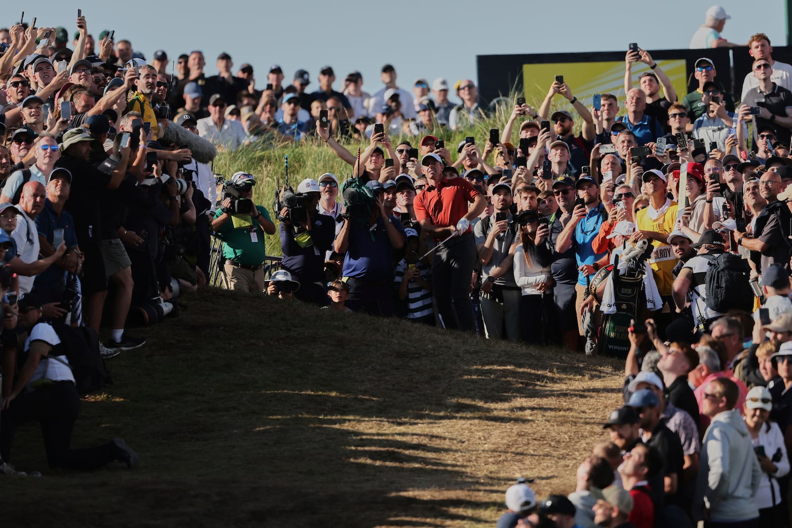 Rory McIlroy of Northern Ireland plays from the rough on the 17th hole during the third round of the British Open golf championship at the Royal Portrush Golf Club, Northern Ireland, Saturday, July 19, 2025. (AP Photo/Peter Morrison)