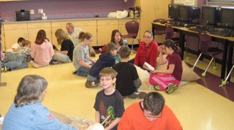 The Mechanicsburg Public Library's PAWS for Reading program, which is celebrating 20 years, over the years since it started in 2003. Contributed