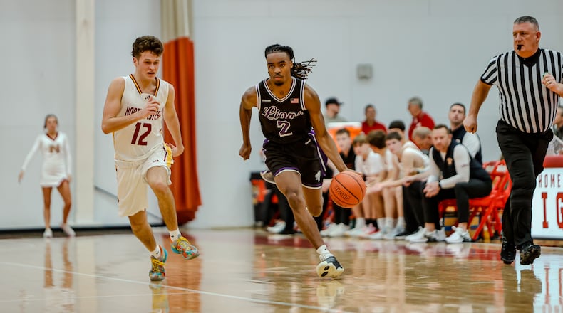 Emmanuel Christian Academy senior Darryus Myers drives past Northeastern's Mason Shockey during their game on Monday, Dec. 30 at Wittenberg University's Pam Evans Smith Arena. MICHAEL COOPER / STAFF