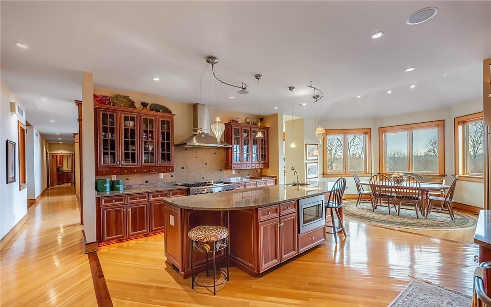 The updated eat in kitchen has heated hardwood floors, recessed lighting and pendant lights. It has an oversized island with a bar sink and professional grade appliances, including a gas range with double ovens. CONTRIBUTED