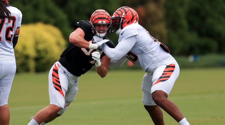 Cincinnati Bengals' Sam Hubbard, left, rushes against Bobby Hart, right, during NFL football camp in Cincinnati, Tuesday, Aug. 18, 2020. (AP Photo/Aaron Doster)