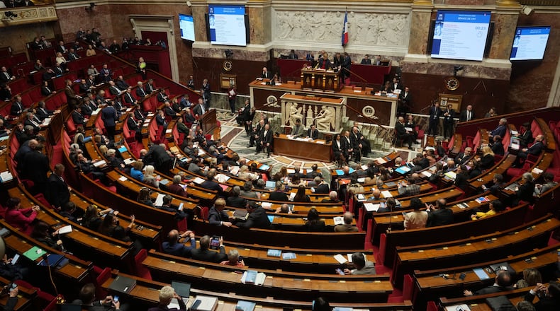 Parliament members sit as France's National Assembly vote on a national health care budget that would suspend Macron's unpopular pension reform raising the retirement age, in Paris, France, Tuesday, Dec. 9, 2025. (AP Photo/Michel Euler)