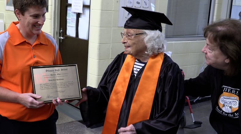 Ruby Lois Hicks, 96, gets her Stivers High School diploma from Liz Whipps, (right) Dean of Arts, and Sarah Bennett, president of the alumnae association. JEFF CROWELL/CONTRIBUTED