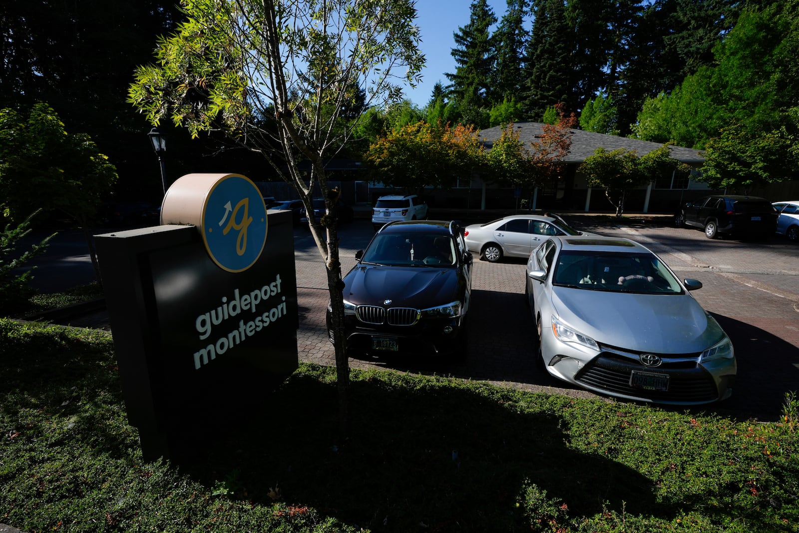 Children are dropped off at the Guidepost Montessori school on Friday, July 18, 2025, in Beaverton, Ore. (AP Photo/Jenny Kane)