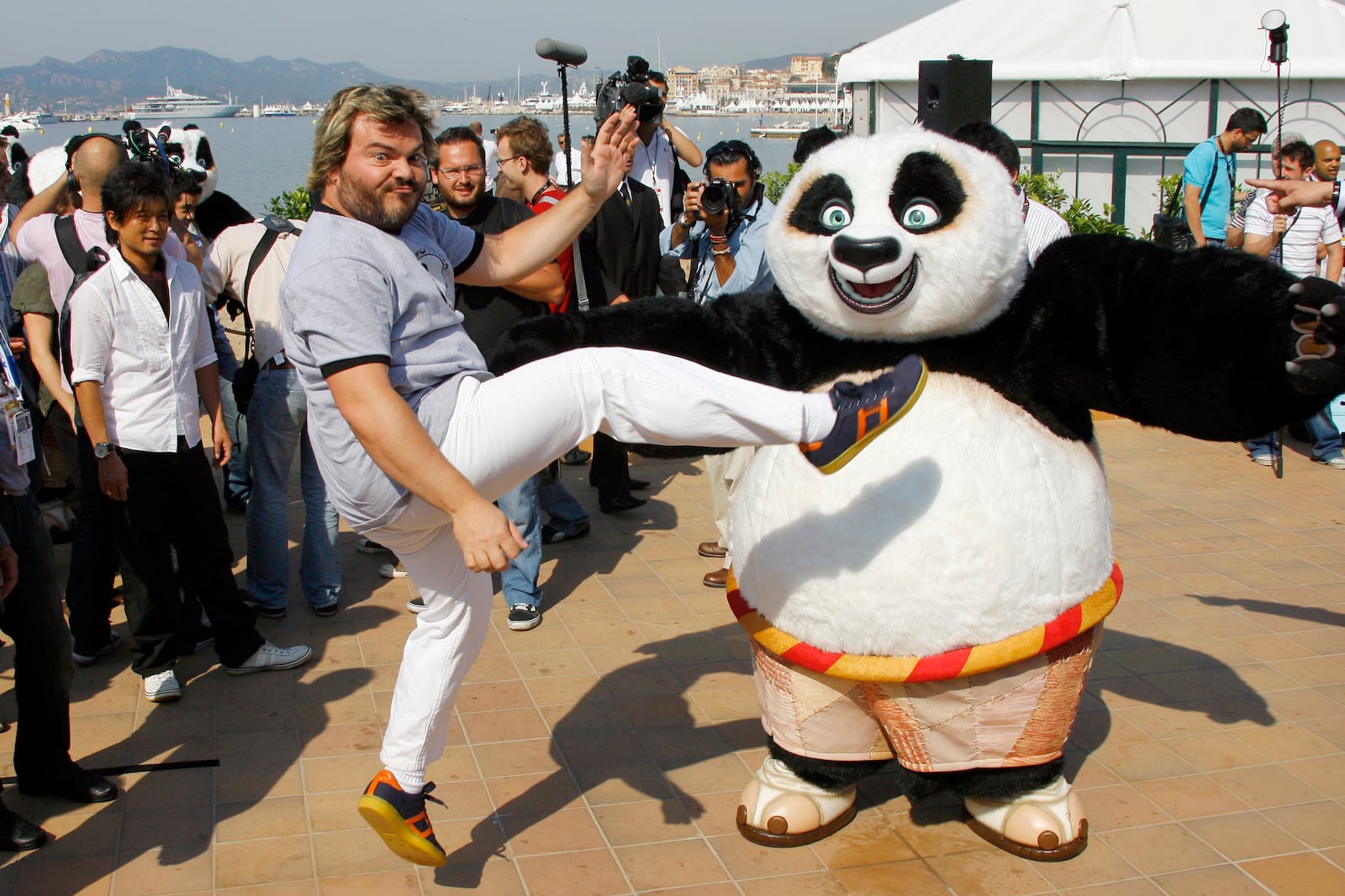 FILE - Actor Jack Black, centre, and Tatsuya Yamaguchi, left, participate in a stunt on the Carlton beach pier for the film "Kung Fu Panda" during the 61st Cannes International Film Festival in Cannes, southern France, Wednesday, May 14, 2008. (AP Photo/Francois Mori, File)