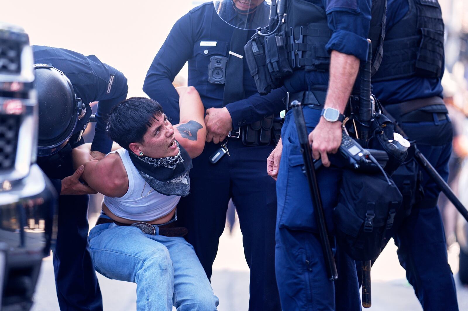 FILE - A protester is detained in downtown Los Angeles, Sunday, June 8, 2025, following last night's immigration raid protest. (AP Photo/Eric Thayer, File)