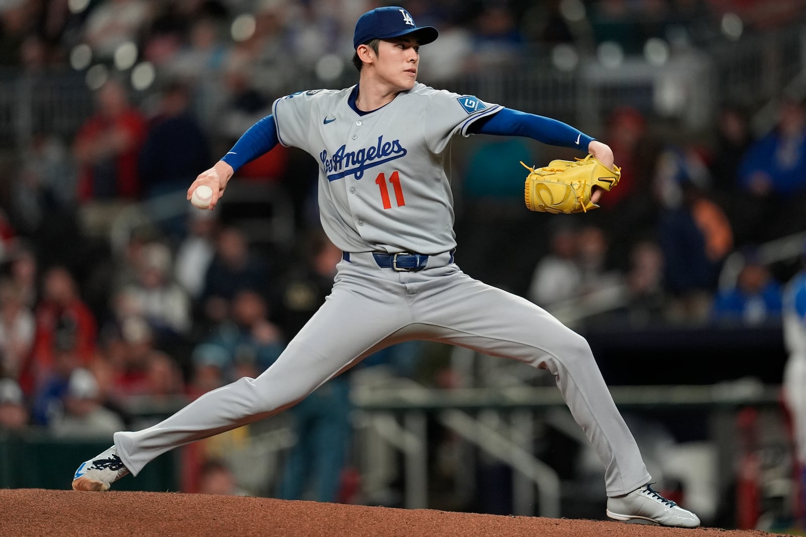 Los Angeles Dodgers pitcher Roki Sasaki (11) delivers against the Atlanta Braves in the first inning of a baseball game, Saturday, May 3, 2025, in Atlanta. (AP Photo/Mike Stewart)