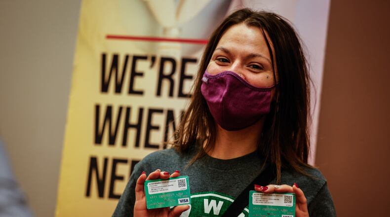 Lindsey Martin, 30, from Dayton, received two $50 visa card after receiving her first COVID-19 vaccine at the Dayton Convention Center Wednesday Dec. 8, 2021. Although not her main reason for getting the shot, the gift cards helped, she said. JIM NOELKER/STAFF