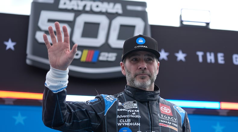 FILE - Jimmie Johnson waves during driver introductions before the NASCAR Daytona 500 auto race at Daytona International Speedway, Feb. 16, 2025, in Daytona Beach, Fla. (AP Photo/John Raoux, File)