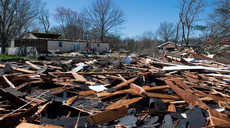 Roof debris from a home off Sharon Road is thrown into the surrounding yards after being ripped off due to damaging winds Saturday night in Newburgh, Ind., Sunday morning, March 29, 2020. A tornado crossed the Ohio River from Kentucky and hit the Newburgh area, Saturday night, tearing roofs off homes and toppling trees and power lines. (MaCabe Brown /Evansville Courier & Press via AP)