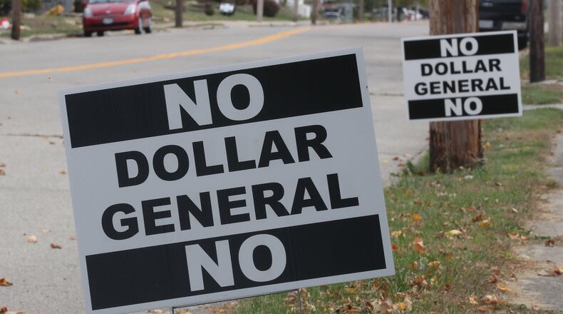 “No Dollar General” signs line Main Street in South Vienna as residents protest the proposed new business location. BILL LACKEY/STAFF