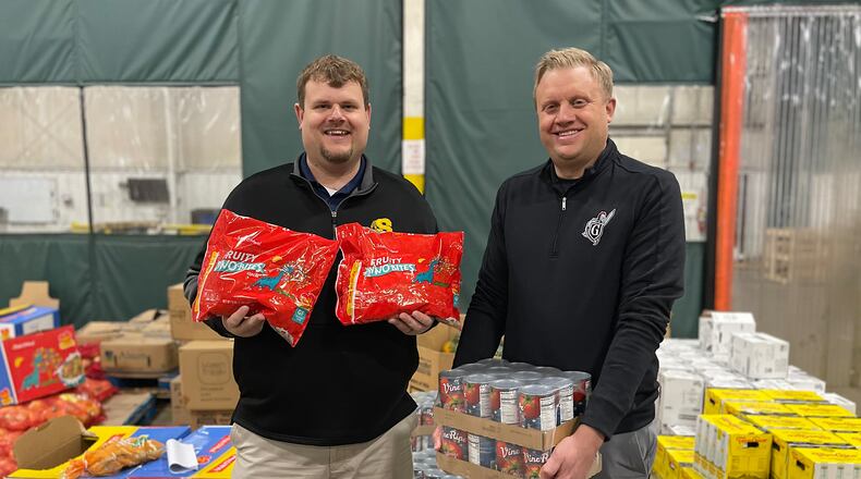 The Clark-Shawnee Local School District has challenged the Greenon Local School District to a canned food drive competition. The competition will run from Dec. 4-8 in both districts, in which all canned food donated by students and staff will be given to the Second Harvest Food Bank. Clark-Shawnee Superintendent Brian Kuhn, left, is shown with Greenon Superintendent Darrin Knapke. CONTRIBUTED