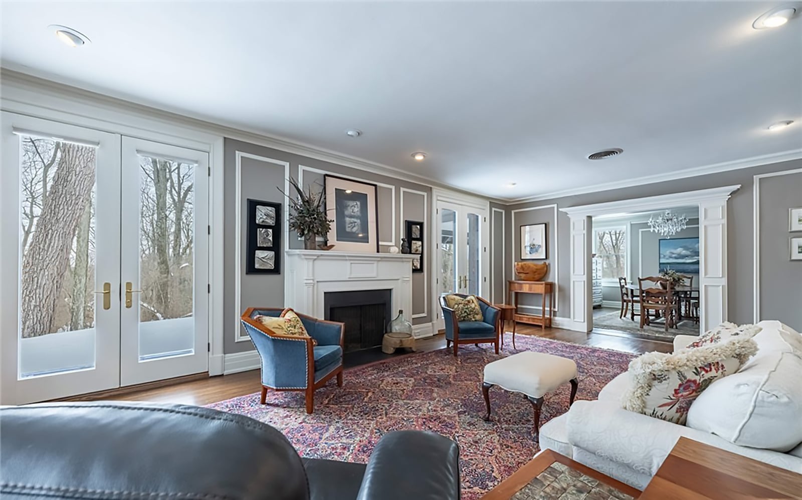 The living room has hardwood floors, a fireplace with wood mantel, recessed lighting and exterior doors opening to the rear patio. CONTRIBUTED