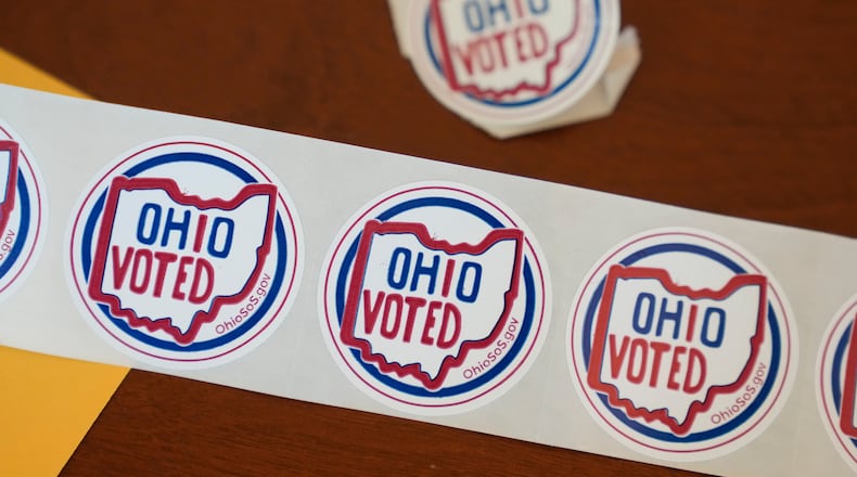 "Ohio Voted" stickers await voters after they cast their ballots at the Meadowbook Golf Club in Clayton, Ohio Tuesday, Nov. 8, 2022. (AP Photo/Michael Conroy)
