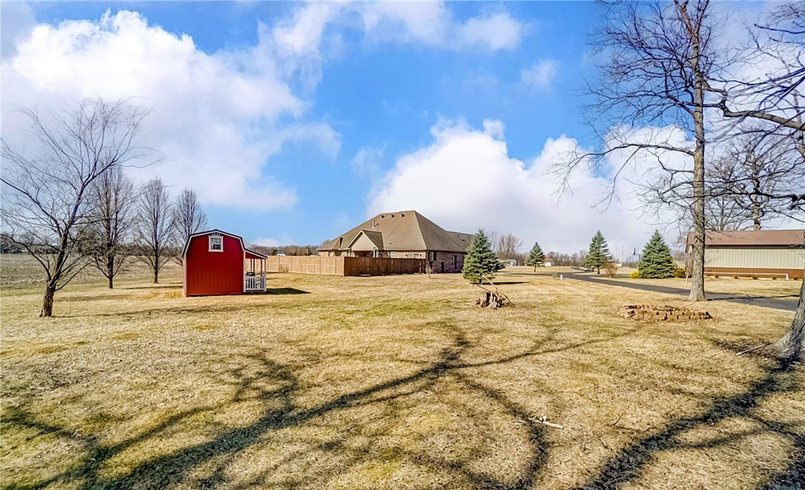 The 30-acre property includes two large pole barns and a shed.