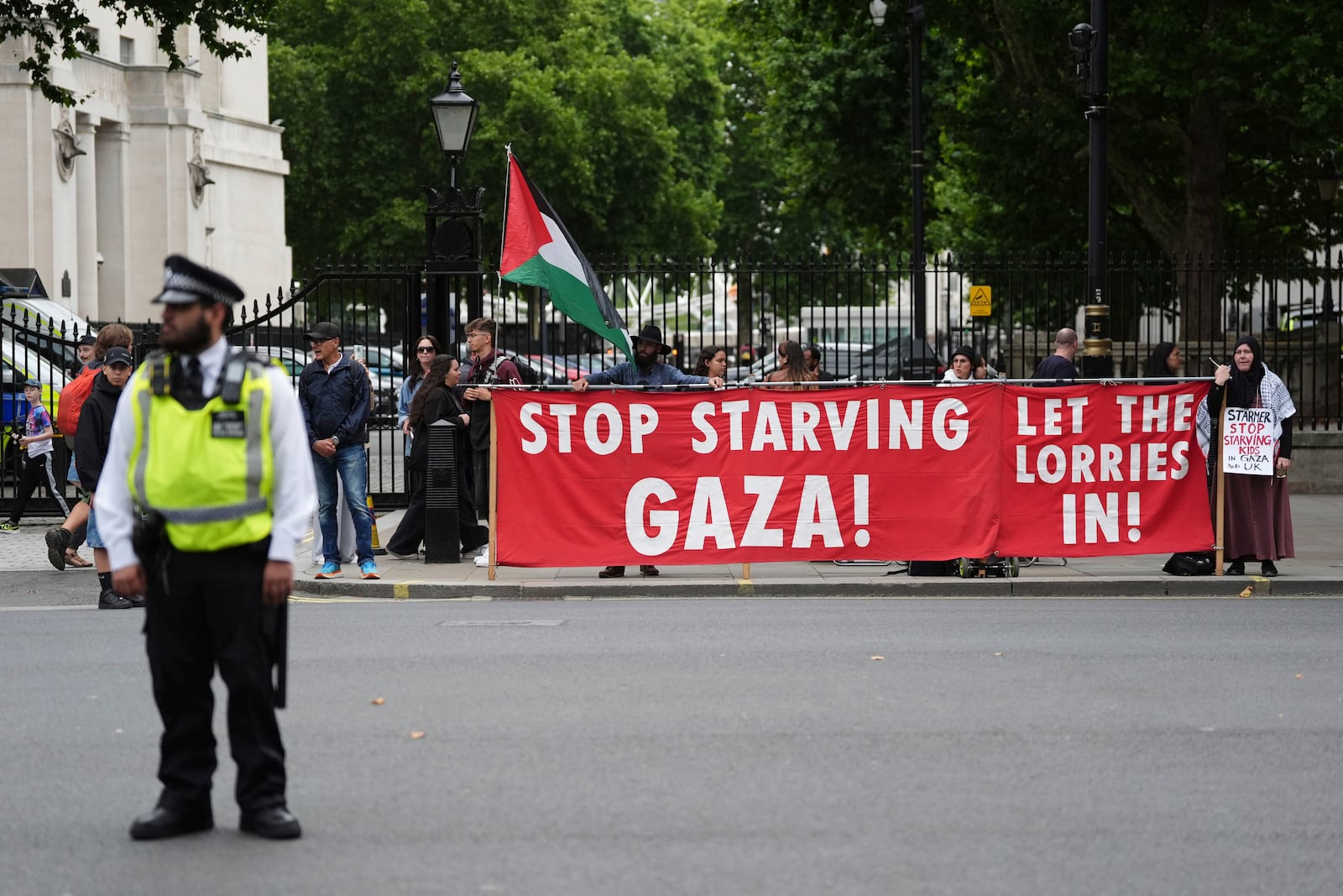 People take part in a protest outside Downing Street in London, Tuesday July 29, 2025, as Prime Minister Keir Starmer gathered senior ministers for an urgent Cabinet meeting on Gaza. (Jonathan Brady/PA via AP)