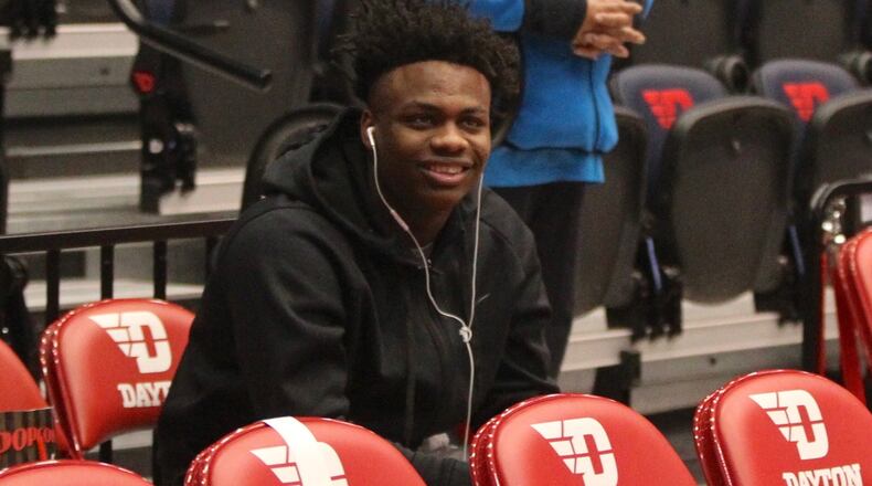 Posh Alexander sits behind the Dayton bench on Saturday, Feb. 2, 2019, at UD Arena.