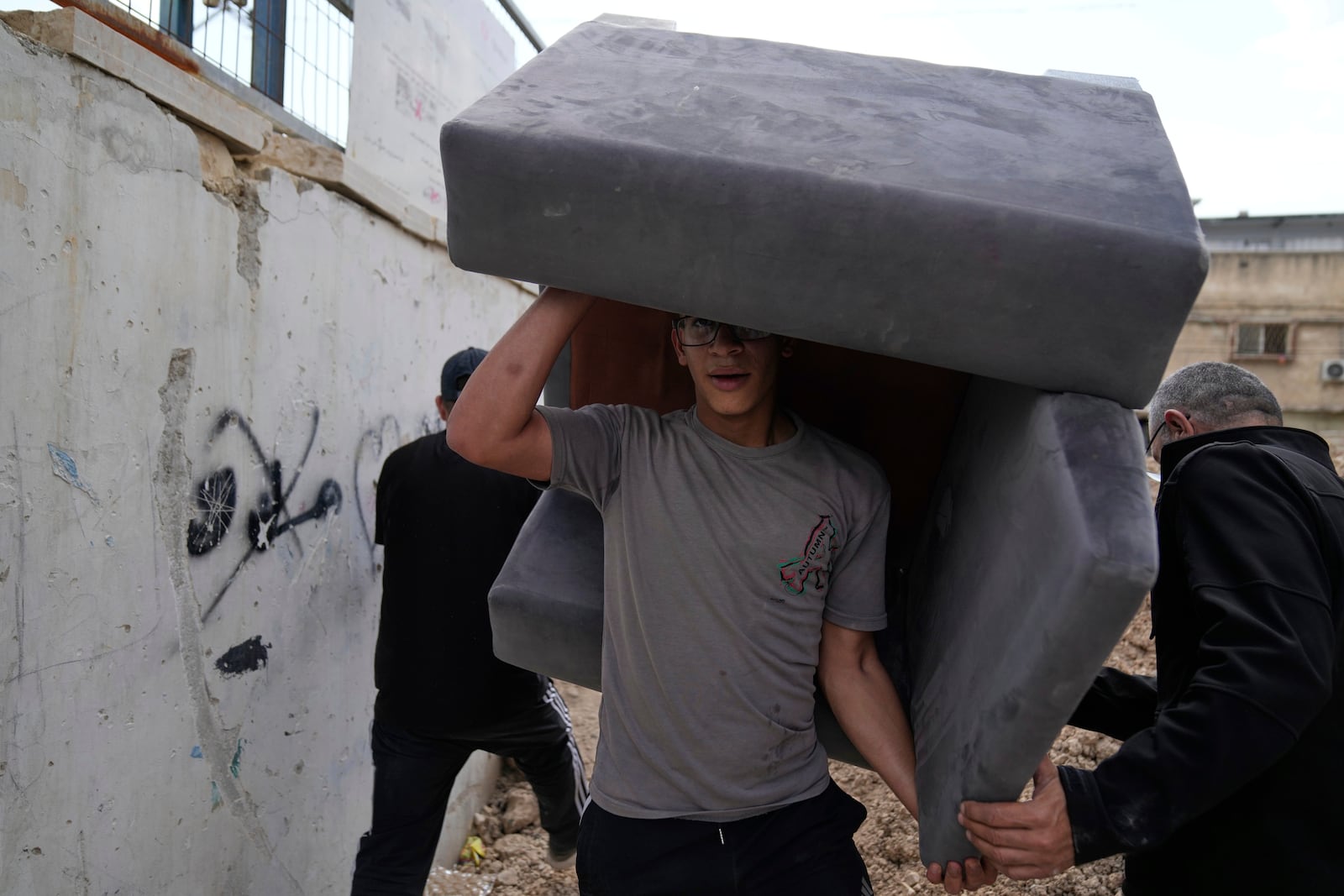 Residents of the now evacuated refugee camp of Tulkarem return to collect belongings before the destruction of their homes as Israeli forces prepare to carry out the demolition of 116 homes across the two refugee camps of the Israeli occupied West Bank city of Tulkarem, Friday, May 2, 2025. (AP Photo/Nasser Nasser)