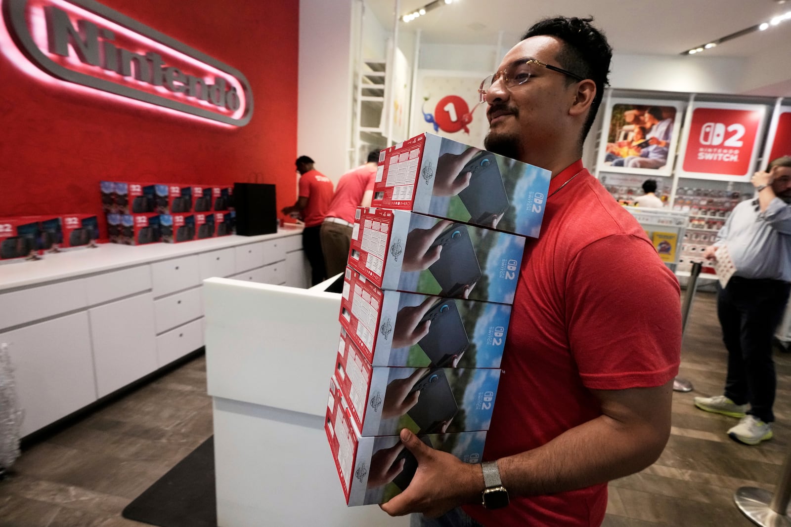 A stack of Nintendo Switch 2 devices is restocked at the Nintendo store in New York's Rockefeller Center, Thursday, June 5, 2025. (AP Photo/Richard Drew)