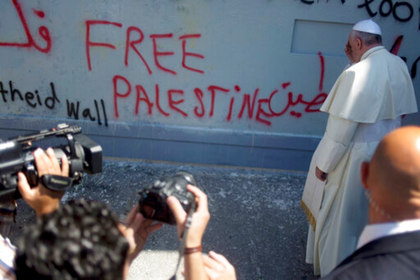 FILE - Pope Francis prays at Israel's separation barrier on his way to a Mass in Manger Square next to the Church of the Nativity, traditionally believed to be the birthplace of Jesus Christ, in the West Bank city of Bethlehem, Sunday, May 25, 2014. (AP Photo/Ariel Schalit, file)