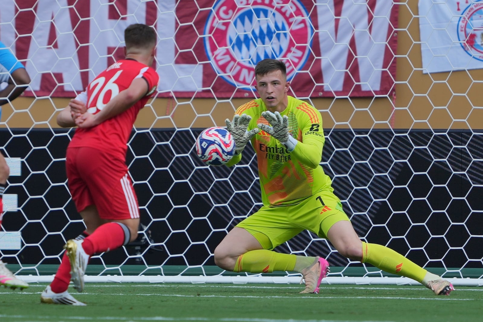 Benfica's Anatoliy Trubin blocks a shot during the Club World Cup Group C soccer match between Benfica and Bayern Munich in Charlotte, N.C., Tuesday, June 24, 2025. (AP Photo/Chris Carlson)