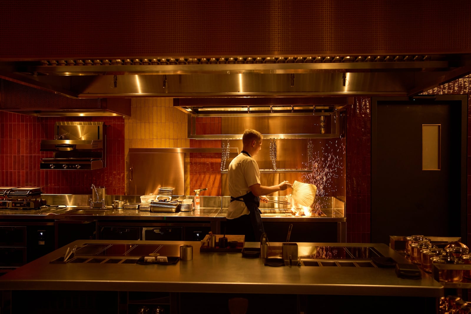 A chef lights charcoal at FZN Restaurant on Palm Jumeirah in Dubai, United Arab Emirates, Friday, June 13, 2025. (AP Photo/ Fatima Shbair)