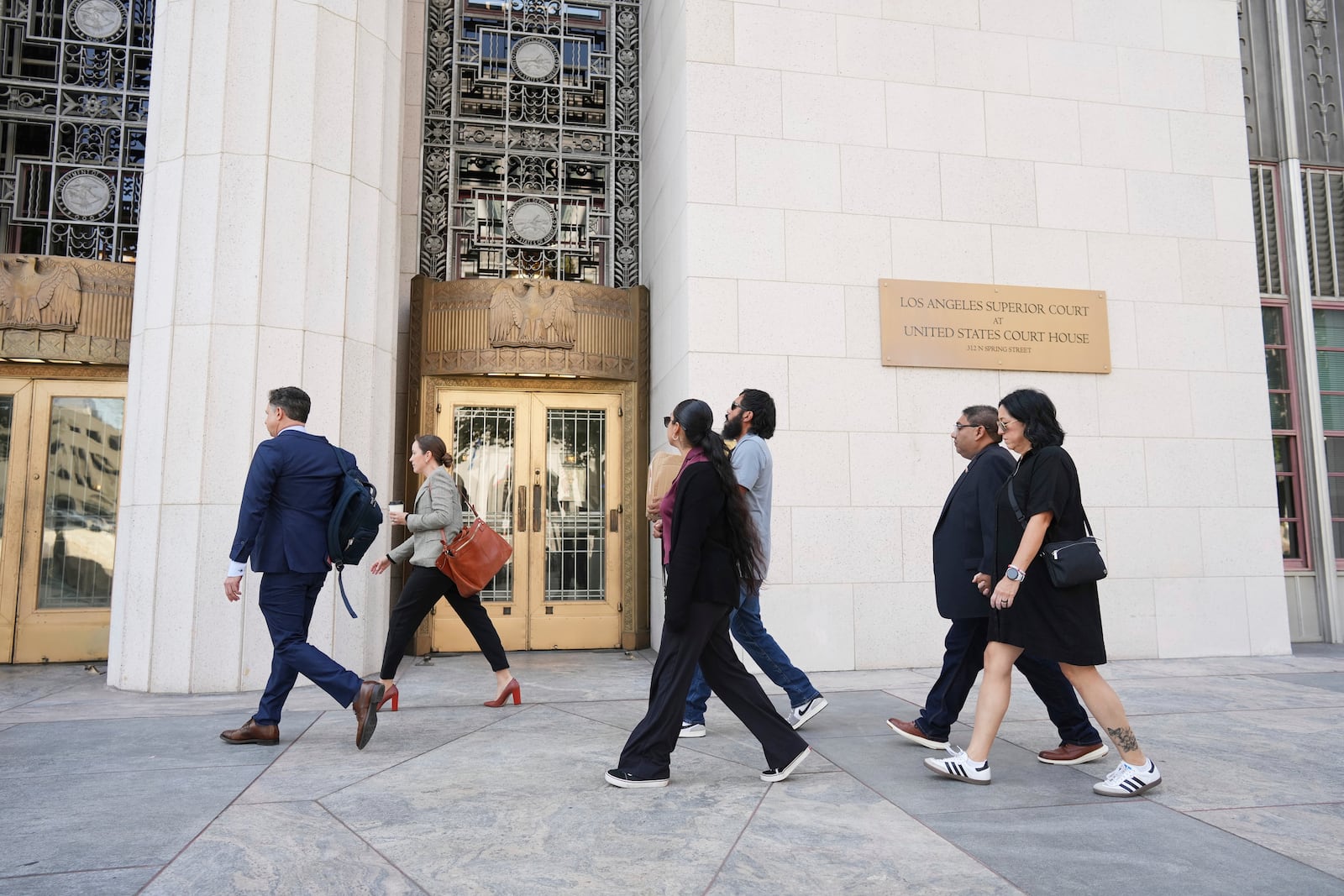 Plantiffs and their lawyers arrive for a court hearing in a lawsuit between victims' families in the 2022 Uvalde, Texas school shooting and Meta Platforms on Friday, July 18, 2025, in Los Angeles. (AP Photo/Eric Thayer)