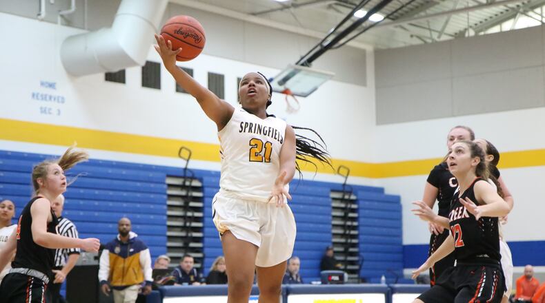 Springfield's Destiny Wells puts up a shot during a game against Beavercreek last season. The Wildcats are dedicating the season to Wells, who died in a car accident in August. Michael Cooper/CONTRIBUTED