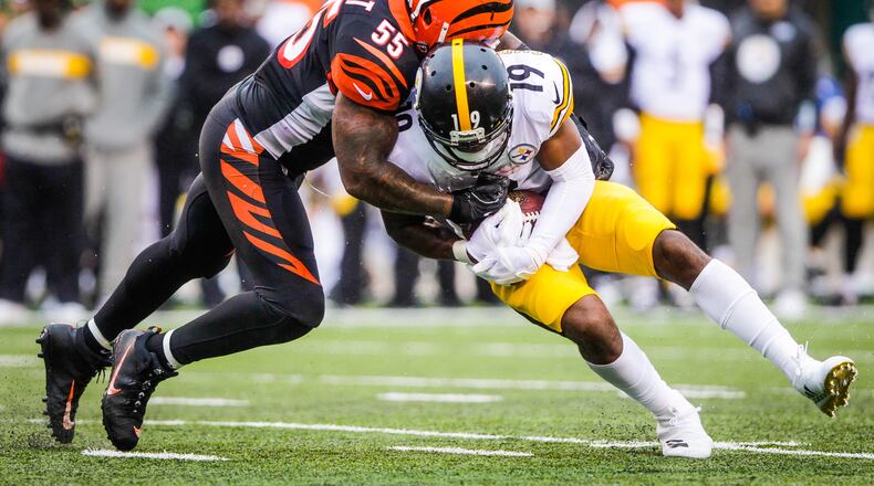 Cincinnati Bengals linebacker Vontaze Burfict tackles Pittsburgh Steelers wide receiver JuJu Smith-Schuster during their game Sunday, Oct. 14 at Paul Brown Stadium in Cincinnati. The Steelers won 28-21. NICK GRAHAM/STAFF