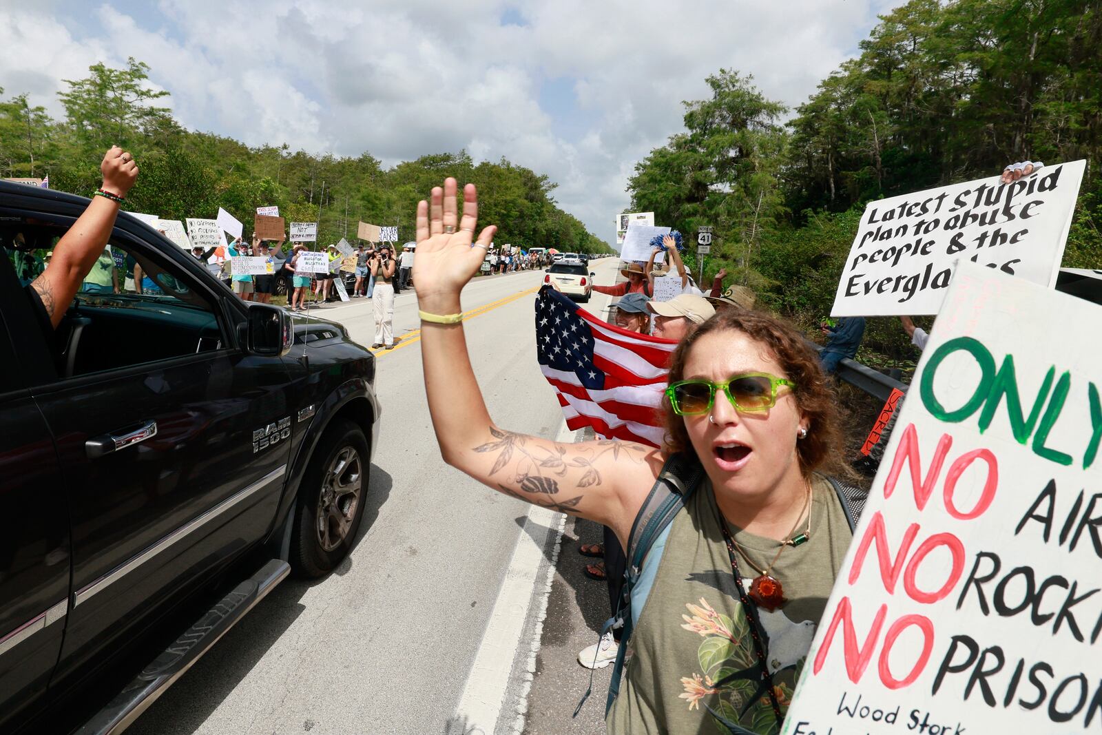 Environmental advocates and protesters at the Dade-Collier Training and Transition Airport on Tamiami Trail E, Ochopee, Fla., on Saturday, June 28, 2025, object to the "Alligator Alcatraz" being built at the facility. (Mike Stocker /South Florida Sun-Sentinel via AP)