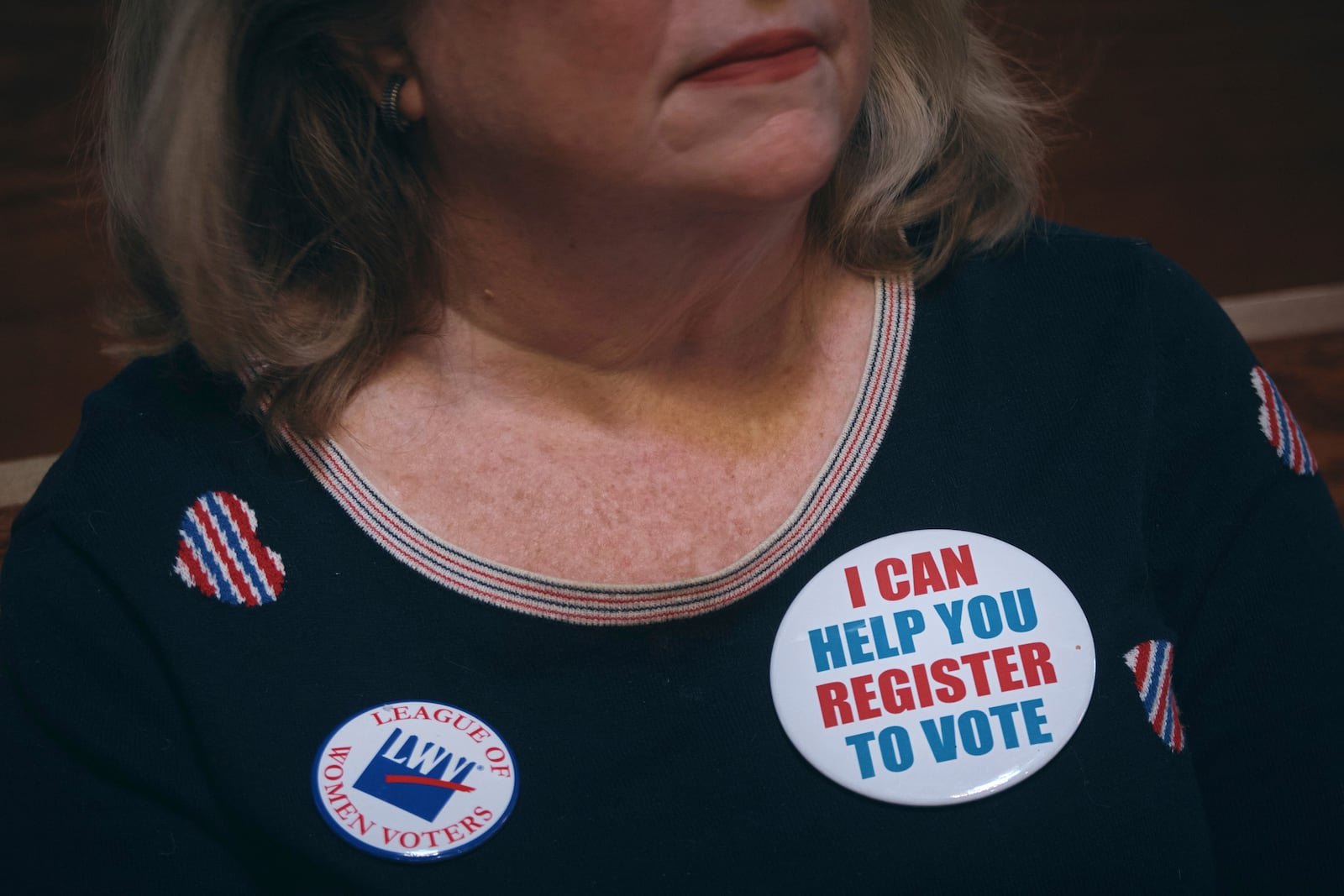 Voting activist Danna Ward listens to a speaker during a Town Hall and voter registration for school board elections at the Bethany Baptist Church, Saturday, Feb. 1, 2025, in Newark, N.J. (AP Photo/Andres Kudacki)