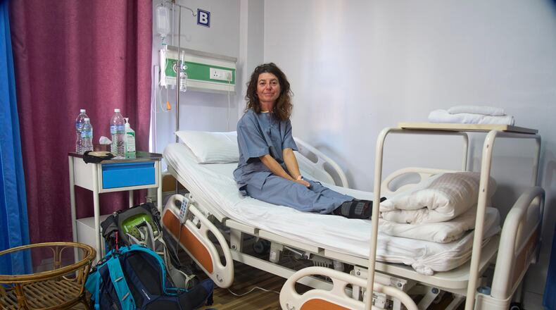 Isabelle Solange, a survivor of an avalanche on Mount Yalung Ri, takes rest after being rescued and airlifted to a hospital in Kathmandu, Nepal, Tuesday, Nov. 4, 2025. (AP Photo/Niranjan Shrestha)