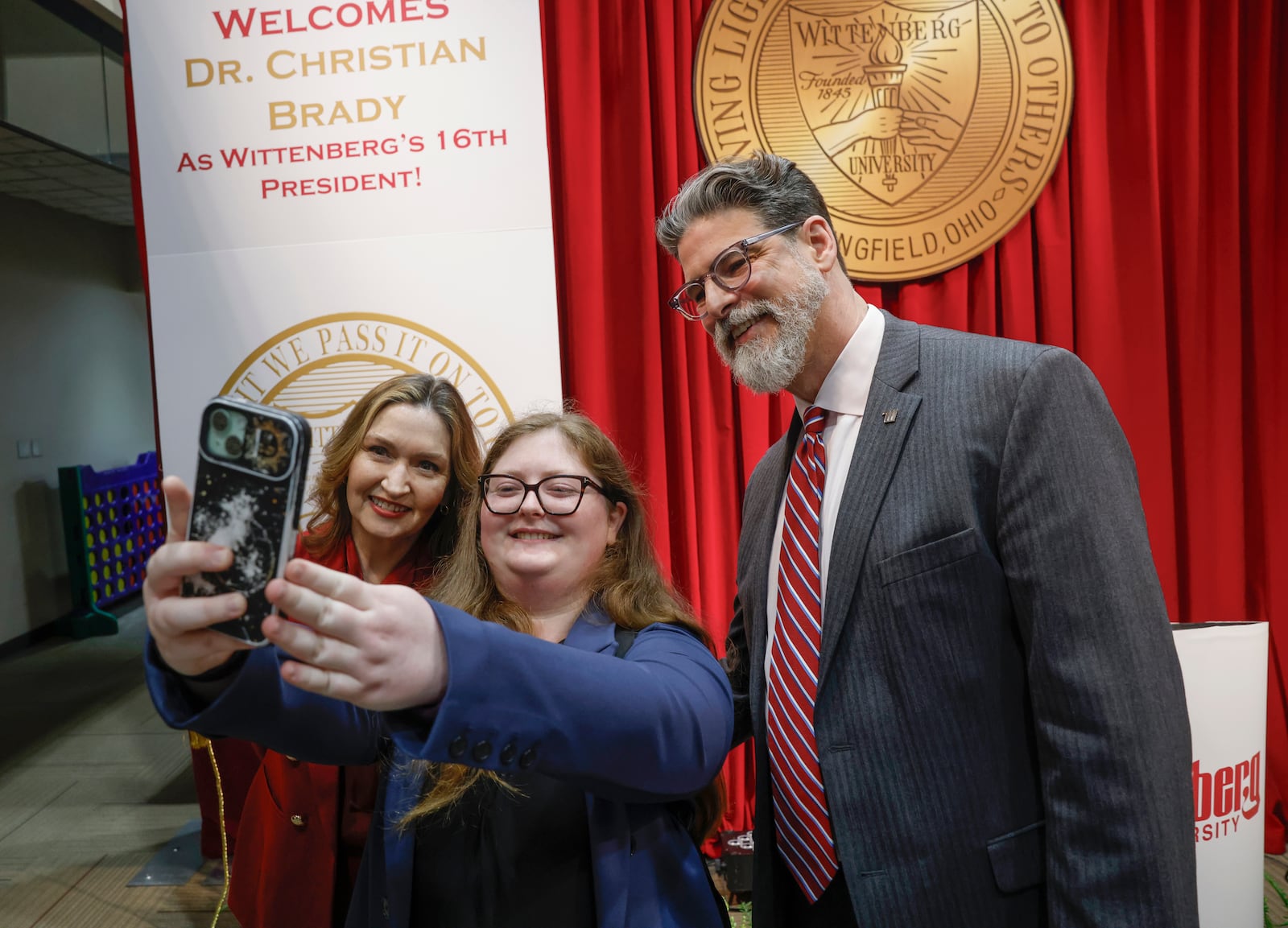 Elizabeth Brady, left, Madison Garside, center, and Dr. Christian M. M. Brady take a photo during an event where Christian was announced as the 16th president on Friday, May 9, 2025, at Wittenberg University. JOSEPH COOKE/STAFF
