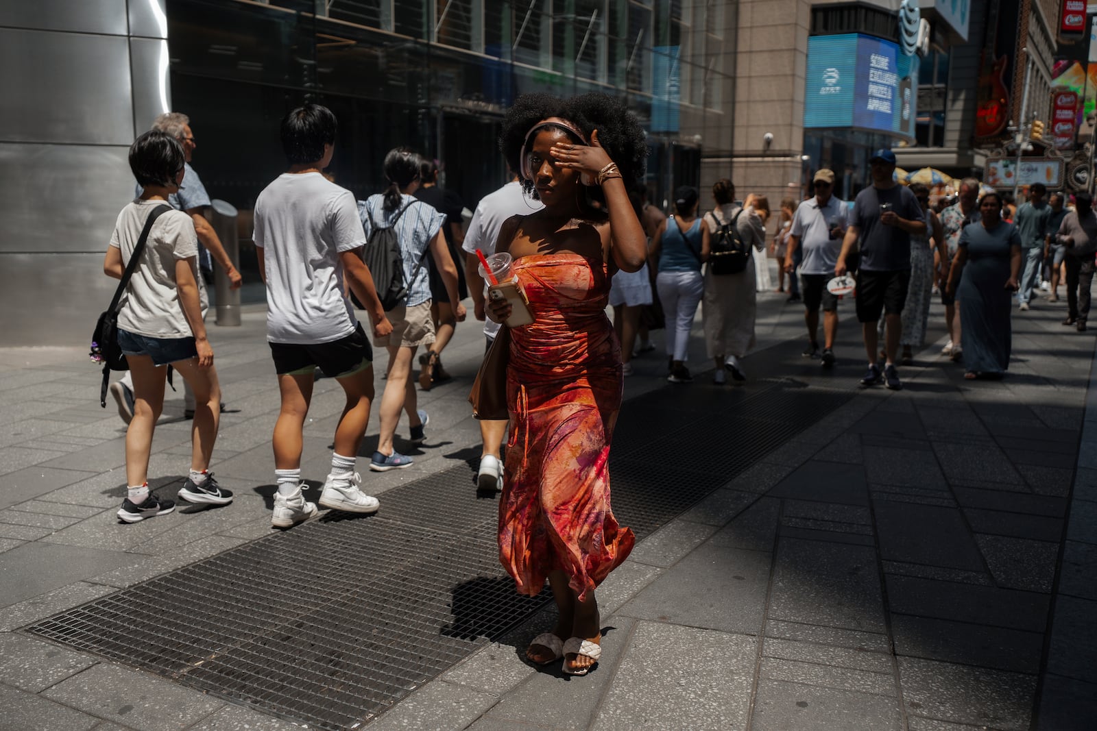 A woman wipes her brow during a heatwave on Tuesday, June 24, 2025, in New York. (AP Photo/Olga Fedorova)