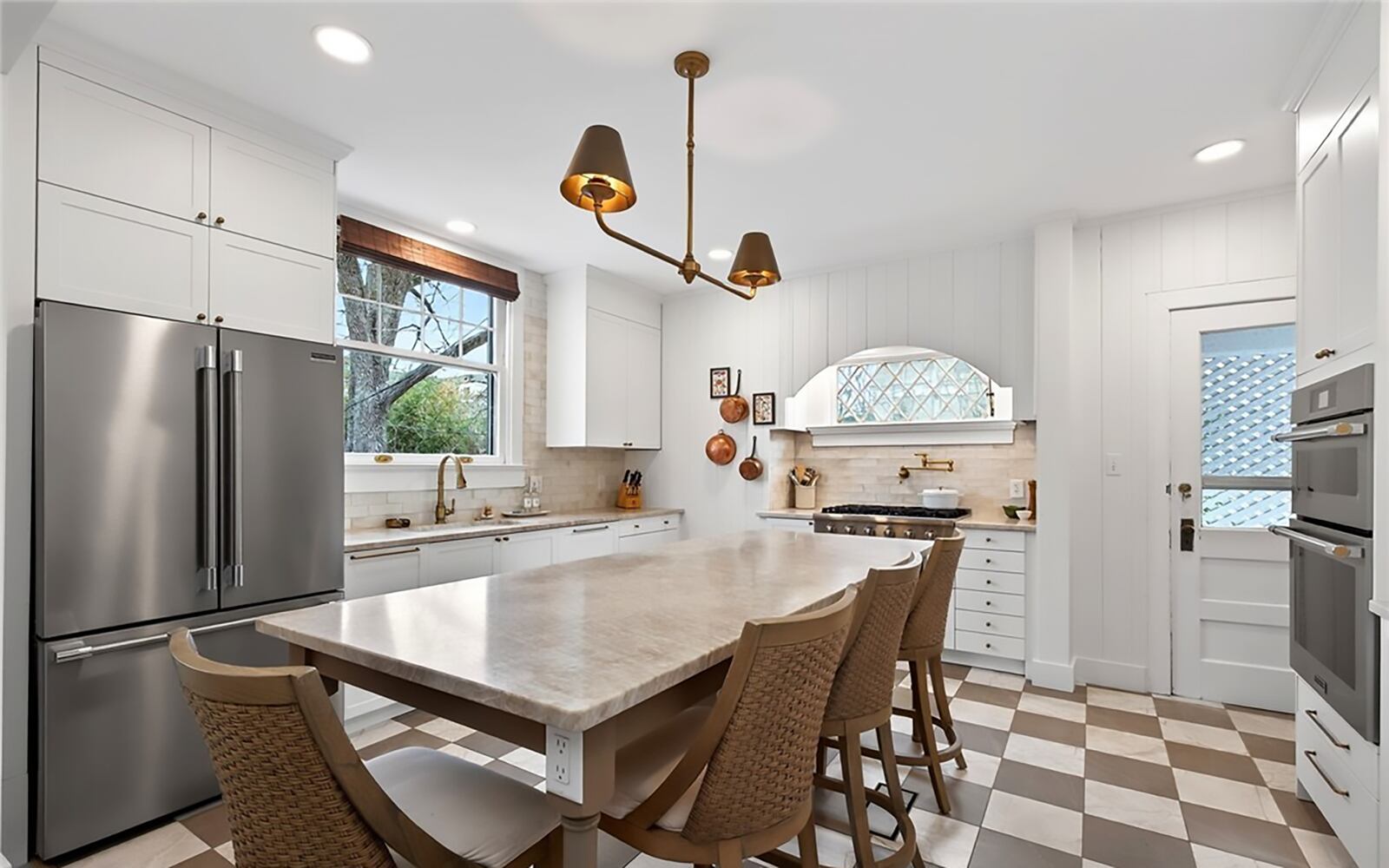 The newly updated kitchen has professional quality appliances, a tile floor, updated cabinetry and a new island with bar seating. CONTRIBUTED