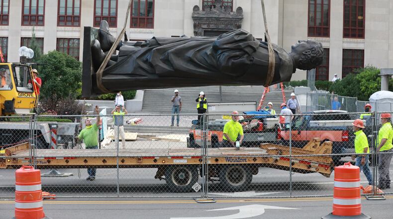 Workers remove the Christhopher Columbus statue on the Broad Street side of Columbus City Hall Wednesday, July 1, 2020. The city says it will be replaced with a different statue or artwork that reflects diversity. A city news releaase said it will be placed in safekeeping at a secure city facility. The Christopher Columbus statue was a gift from the people of Genoa, Italy, in 1955. (Doral Chenoweth/Columbus Dispatch)