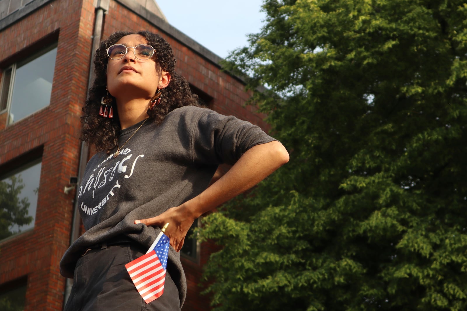 Harvard University junior Avinashi Bhandari stands on the podium before speaking at a protest against President Donald Trump's recent sanctions against Harvard in front of Science Center Plaza on Tuesday, May 27, 2025, in Cambridge, Mass. (AP Photo/Leah Willingham)