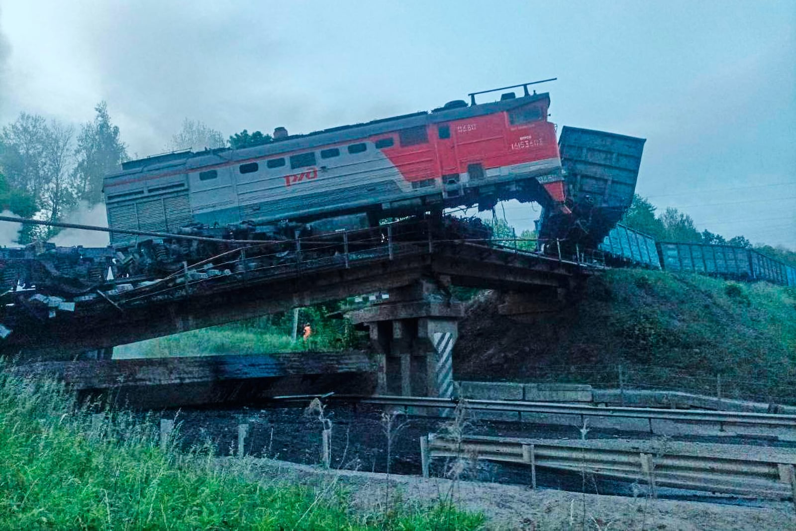 This photo released by Acting Governor of the Kursk Region Alexander Khinshtein telegram channel on Sunday, June 1, 2025, shows a view of a damaged bridge after the crash of a freight train in Russia's Kursk region, which borders Ukraine. (Acting Governor of the Kursk Region Alexander Khinshtein via AP)