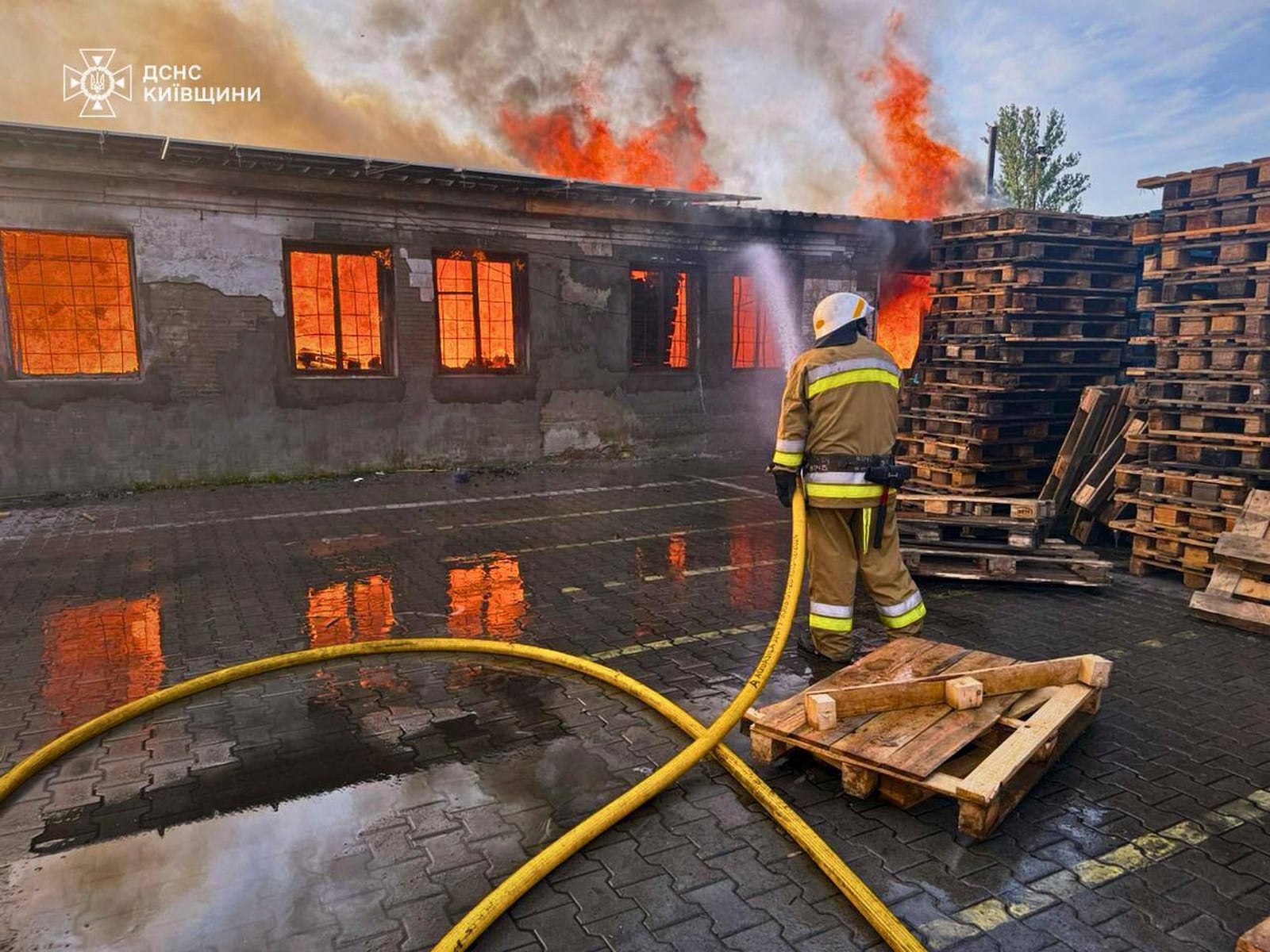 In this photo provided by the Ukrainian Emergency Service, a firefighter puts out the fire following a Russian attack in Kyiv region, Ukraine, Wednesday, July 9, 2025. (Ukrainian Emergency Service via AP)