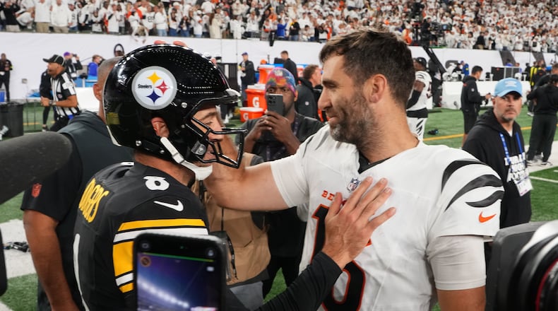 Pittsburgh Steelers quarterback Aaron Rodgers (8) and Cincinnati Bengals quarterback Joe Flacco, right, meet on the field following an NFL football game in Cincinnati, Thursday, Oct. 16, 2025. (AP Photo/Jeff Dean)